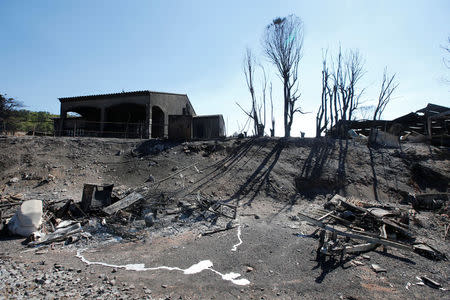 The charred debris of vehicles and a building that were destroyed by fire are seen near a parking lot for camping cars in Bormes-les-Mimosas, in the Var department, France, July 26, 2017, after firefighters evacuated thousands of campers and local residents when a wildfire broke out on France's tourist-thronged Riviera coast overnight. REUTERS/Jean-Paul Pelissier