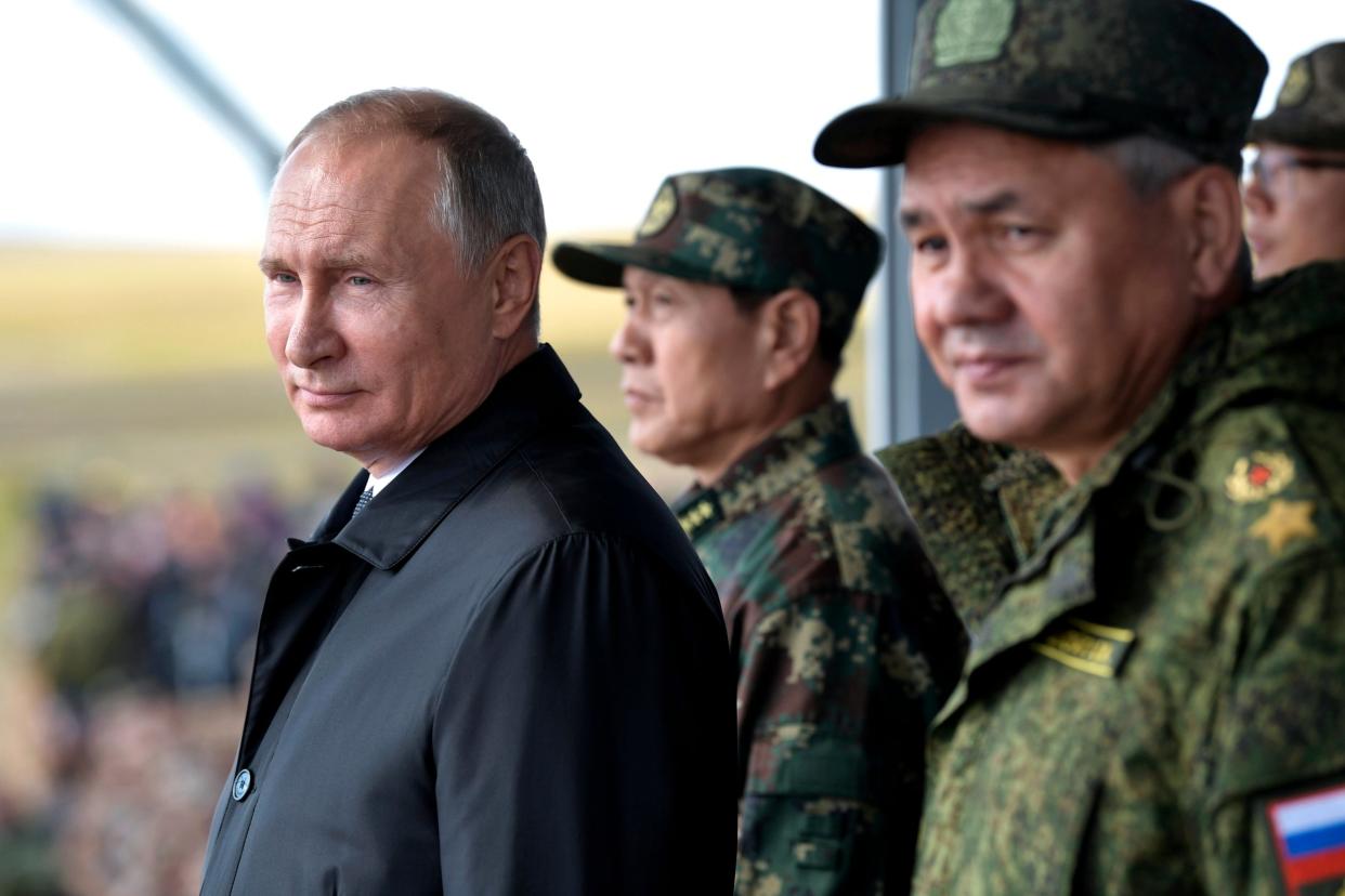 Vladimir Putin and Chinese defence minister Wei Fenghe (centre) watch a military exercise in Siberia: AP