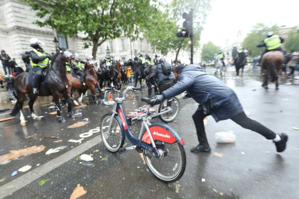 A bicycle is thrown at mounted police Police on horseback in Whitehall following a Black Lives Matter protest rally in Parliament Square, London, in memory of George Floyd who was killed on May 25 while in police custody in the US city of Minneapolis. PA Photo. Picture date: Saturday June 6, 2020. See PA story POLICE Floyd. Photo credit should read:  Yui Mok/PA Wire 