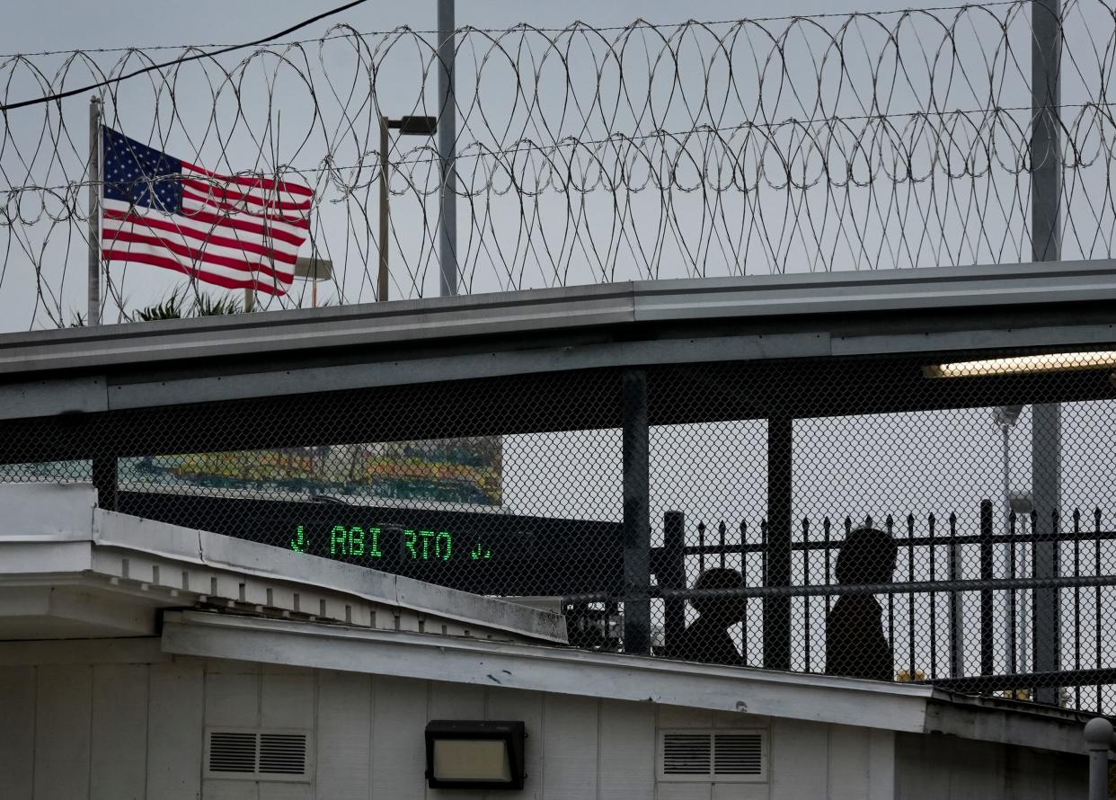 The United States flag flies behind concertina wire at the Gateway International Bridge in Brownsville Wednesday February 28, 2024.