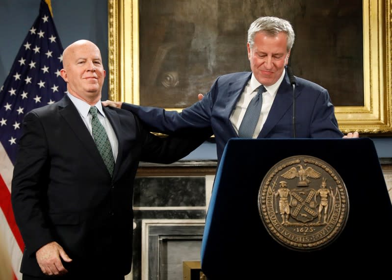 New York City Police Department (NYPD) Commissioner James P. O'Neill is congratulated by New York City Mayor Bill de Blasio, after announcing resignation during a news conference at City Hall in New York