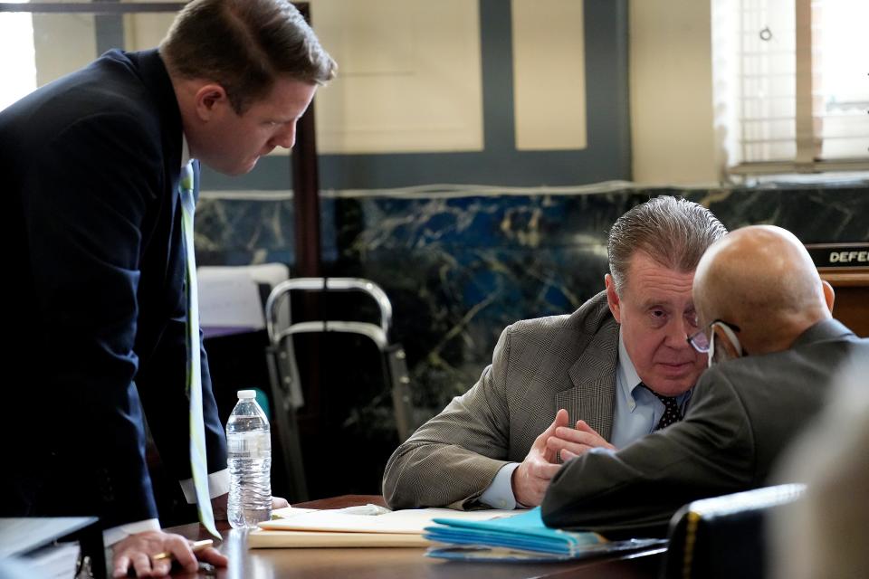 Pro-bono attorneys Jay Clark and David Hine talk with Ohio death-row inmate Elwood Jones during an Aug. 25 hearing. Clark and Hine argued that Jones should be granted a new trial because Hamilton County prosecutors failed to turn over thousands of investigative documents to Jones' original defense team when he was tried in the 1994 beating death of New Jersey grandmother Rhoda Nathan.