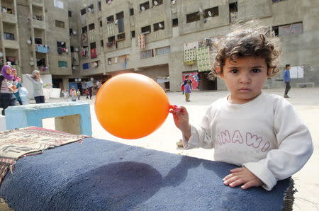 A child plays with a balloon inside a compound for Syrian Refugees in Sidon, south Lebanon April 17, 2015. REUTERS/Ali Hashisho