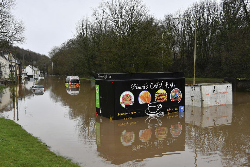 A half submerged fast food van after flooding, in Nantgarw, Wales, Sunday Feb. 16, 2020. Storm Dennis is roaring across Britain with high winds and heavy rains, prompting authorities to issue 350 flood warnings, including a “red warning" alert for life-threatening flooding in south Wales. (Ben Birchall/PA via AP)