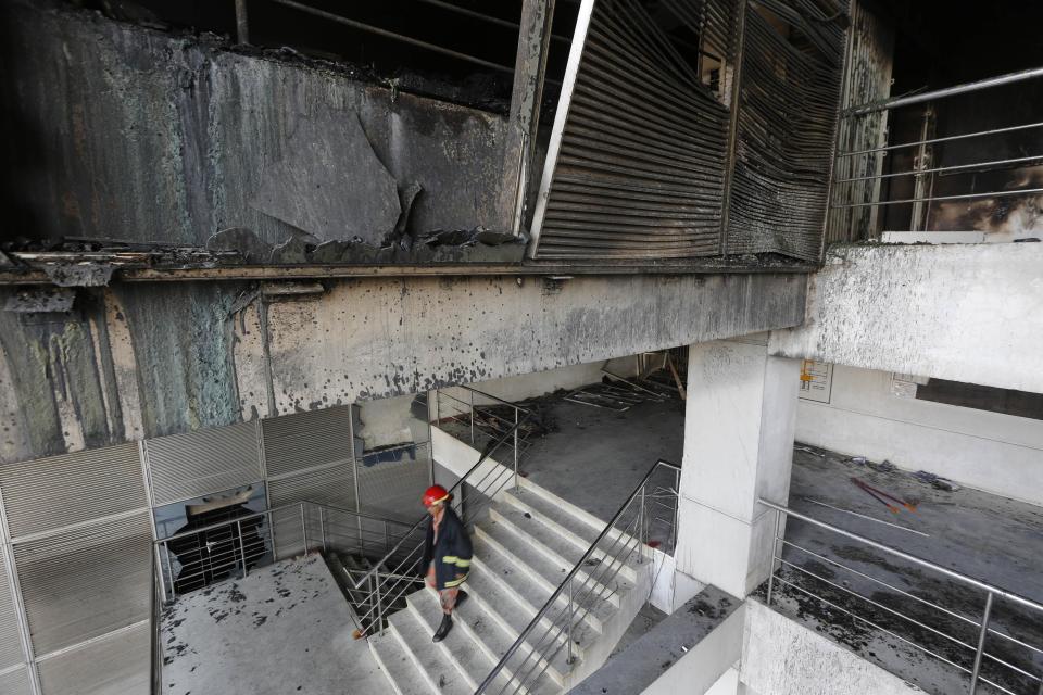 A firefighter inspects the Standard Group garment factory which was on fire in Gazipur