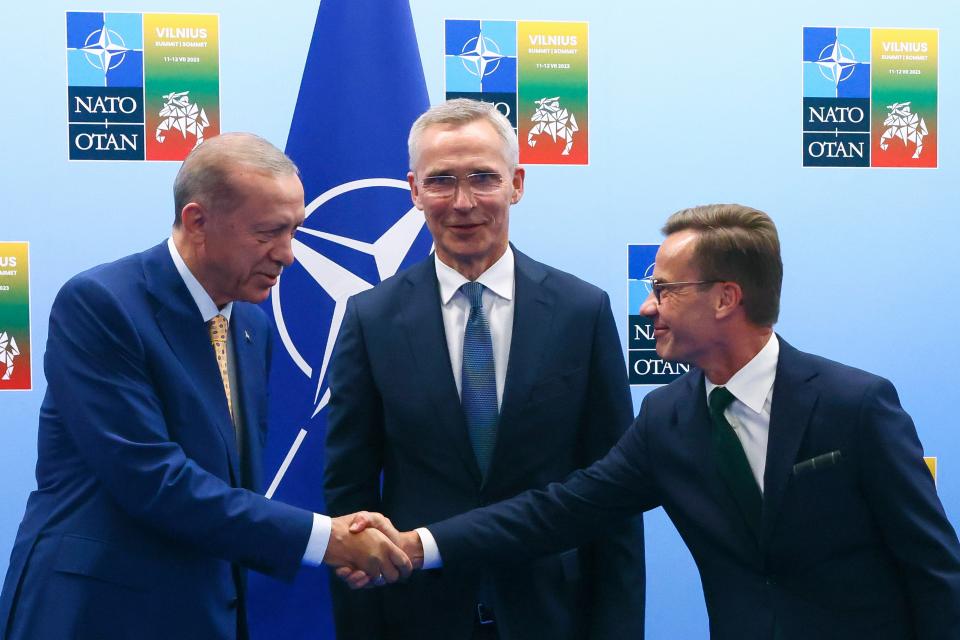 Turkey's President Recep Tayyip Erdogan, left, shakes hands with Sweden's Prime Minister Ulf Kristersson, right, as NATO Secretary General Jens Stoltenberg looks on