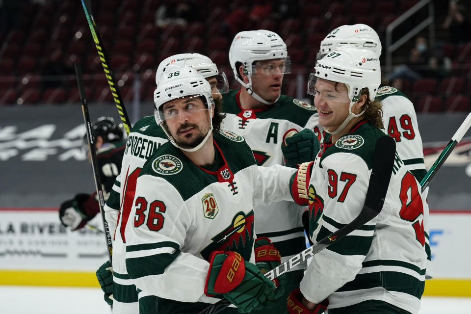 Minnesota Wild Mats Zuccarello (36) celebrates with teammates Kirill Kaprizov (97), Victor Rask (49), Matt Dumba (24) and Jared Spurgeon (46) after scoring a goal against the Arizona Coyotes in the first period during an NHL hockey game, Friday, March 5, 2021, in Glendale, Ariz. (AP Photo/Rick Scuteri)