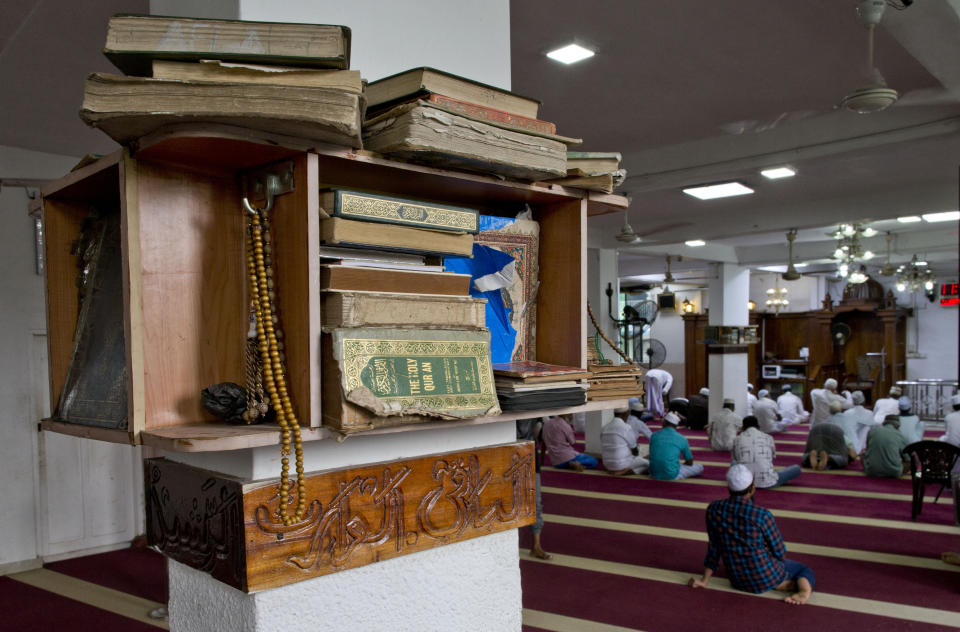 Copies of the holy Quran and prayer breads are kept in a mosque as Muslim men gather to pray in Colombo, Sri Lanka, Friday, April 26, 2019. Hundreds gathered at mosques that conducted Friday prayer services despite warnings of more bomb attacks by Islamic State-claimed militants. And while praying through tears to Allah to help their fellow countrymen, all stressed one thing. The Easter attacks targeting churches and hotels that killed at least 250 people came from people who didn't truly believe the teachings of Islam. (AP Photo/Gemunu Amarasinghe)