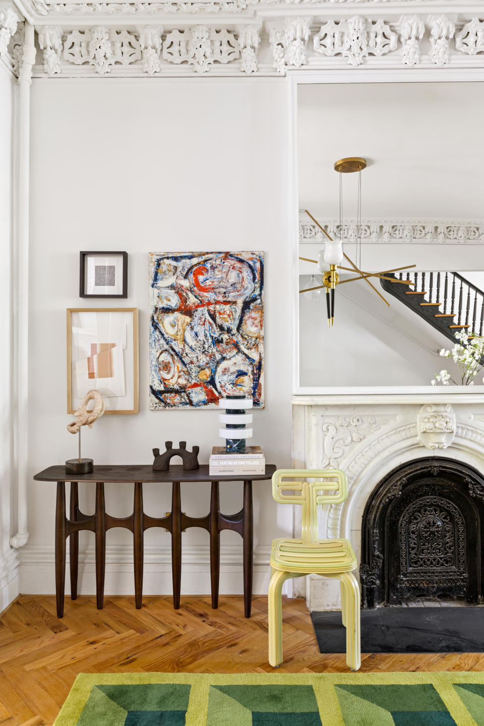 console table with art next to fireplace