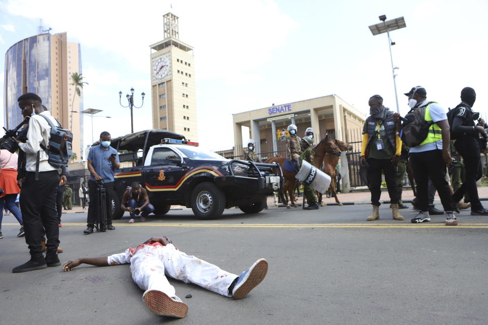 A body of of a man who was shot in the head lies next to the Kenyan parliament during a protest over proposed tax hikes in a finance bill in downtown Nairobi, Kenya Tuesday, June. 25, 2024. (AP Photo/Andrew Kasuku)