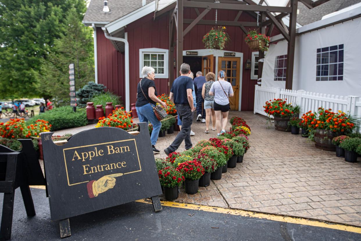 People enter Edwards Apple Orchard on Friday, Aug. 26, 2022, in Poplar Grove.