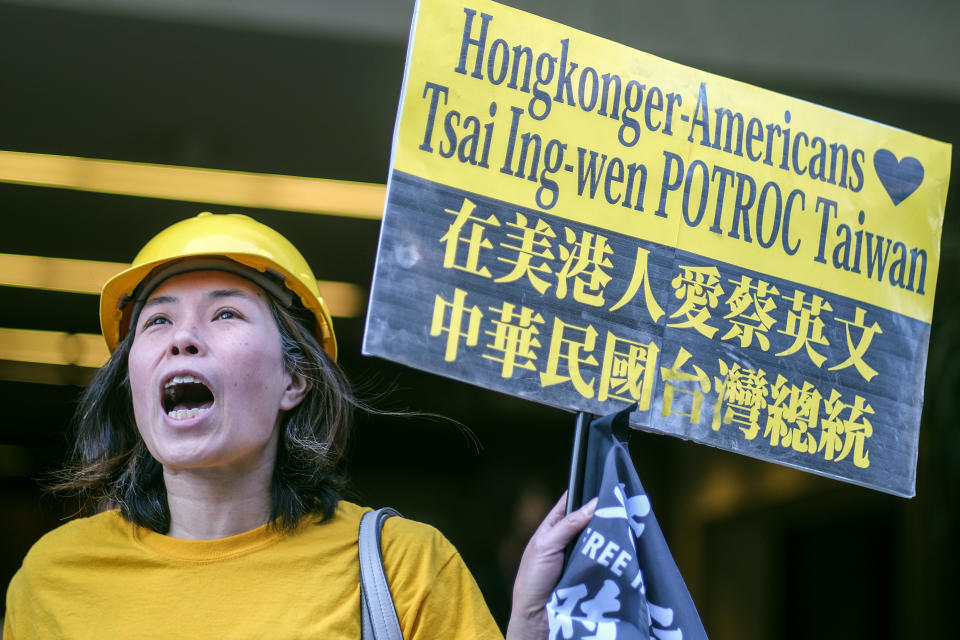 A supporter of Taiwan holds a sign and shouts slogans outside a hotel where Taiwanese President Tsai Ing-wen is expected to arrive in Los Angeles, Tuesday, April 4, 2023. (AP Photo/Ringo H.W. Chiu)
