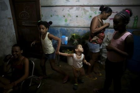 Family members of Yolanda Sanchez, (not pictured), chat in their home in Havana, March 19, 2016. REUTERS/Alexandre Meneghini