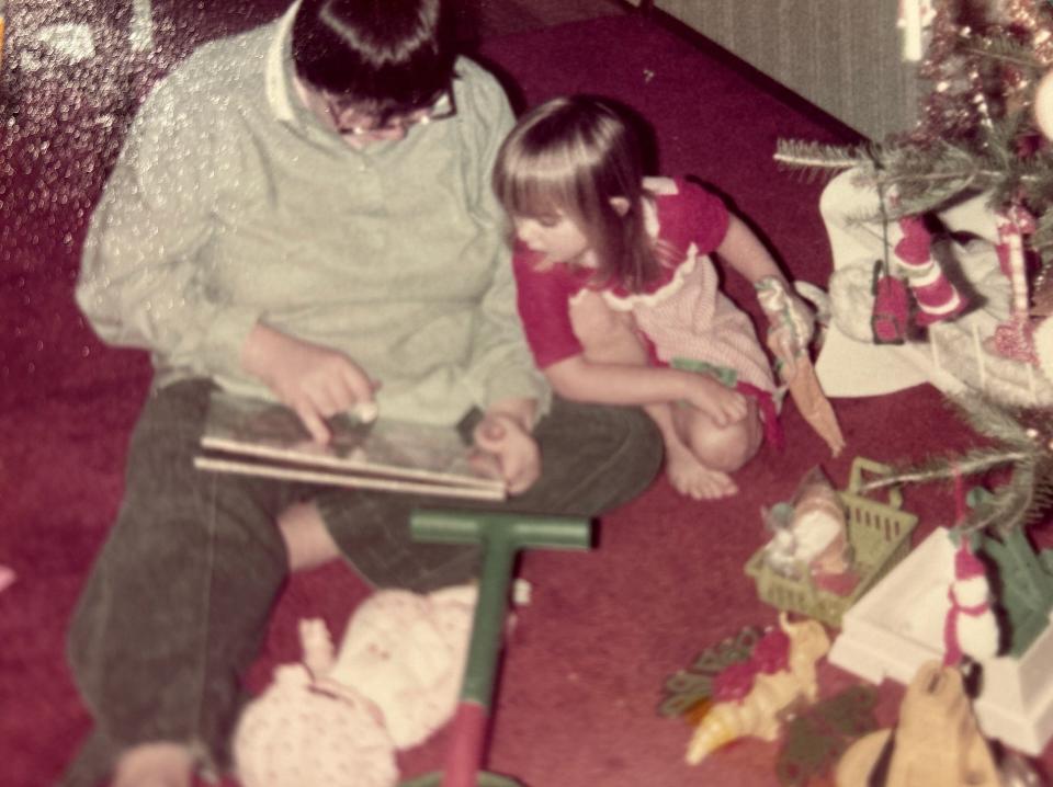 In 1982, Melinda Umezaki (right) holds her first Barbie, which she received for Christmas when she was four years old.