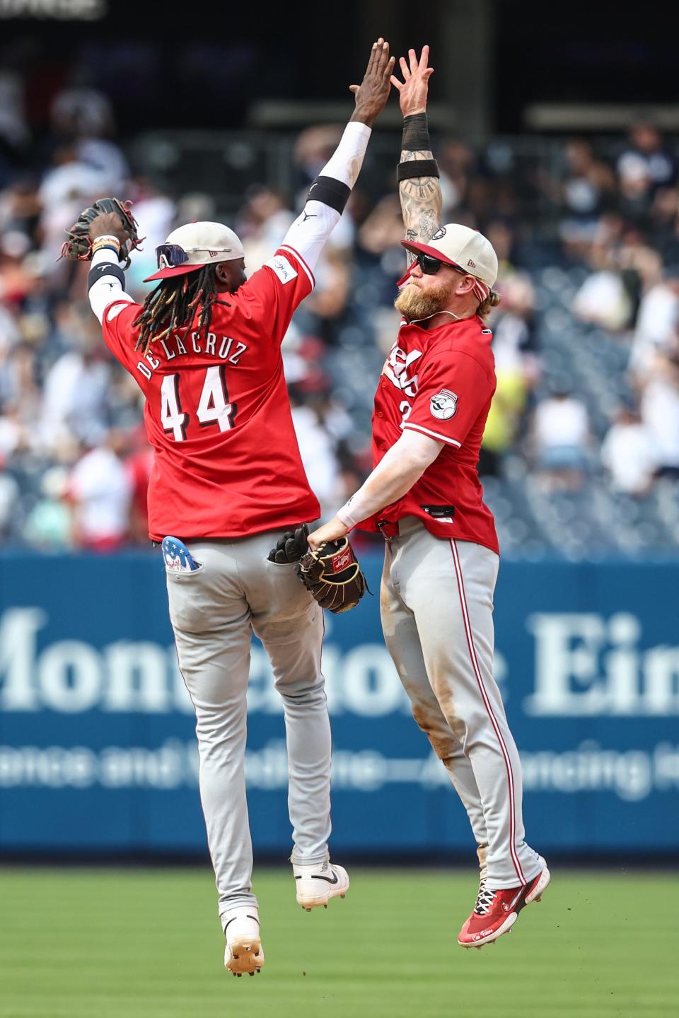 Jul 4, 2024; Bronx, New York, USA; Cincinnati Reds shortstop Elly De La Cruz (44) and right fielder Jake Fraley (27) celebrate after defeating the New York Yankees 8-4 at Yankee Stadium. Mandatory Credit: Wendell Cruz-USA TODAY Sports