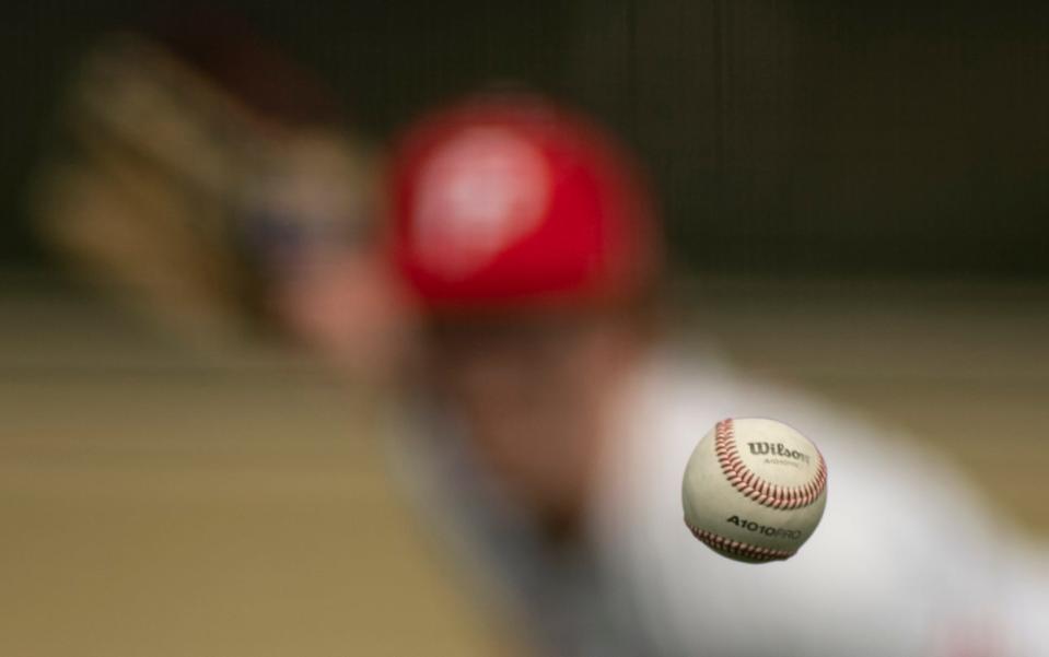 Princeton Community’s Ryne Wilhite (23) pitches against Reitz at Gil Hodges Field in Princeton, Ind., Saturday afternoon, April 2, 2022. Rising prices of baseballs are affecting the sport especially in high schools.