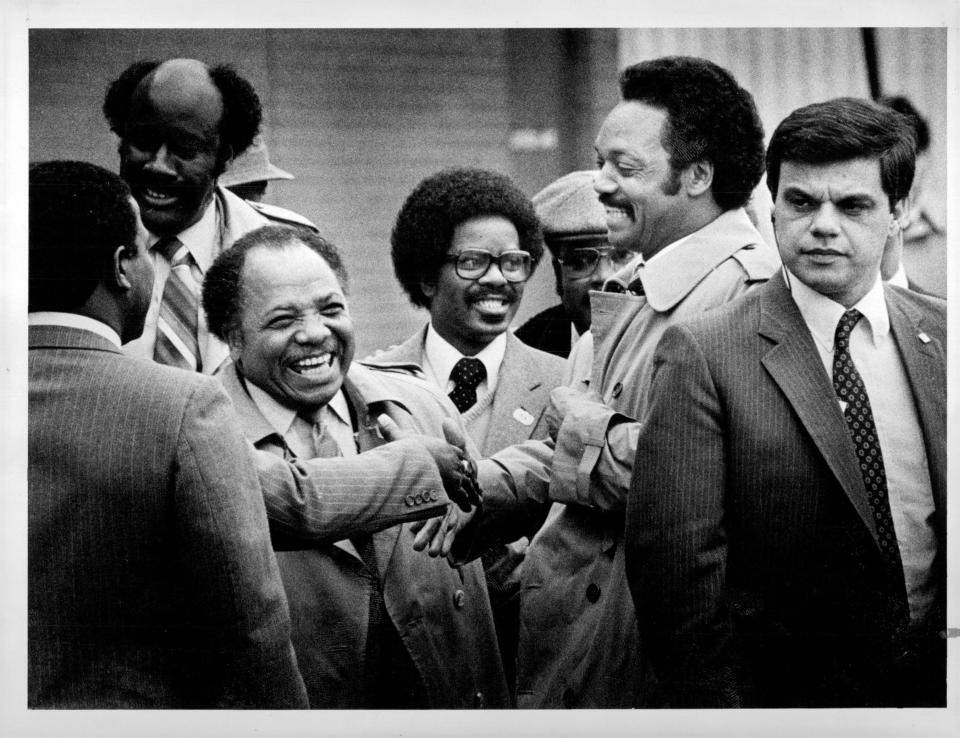 Jesse Jackson, presidential candidate, guarded by Secret Service agent, arrives at The Marketplace Mall Minister Franklin Florence, is third from left.