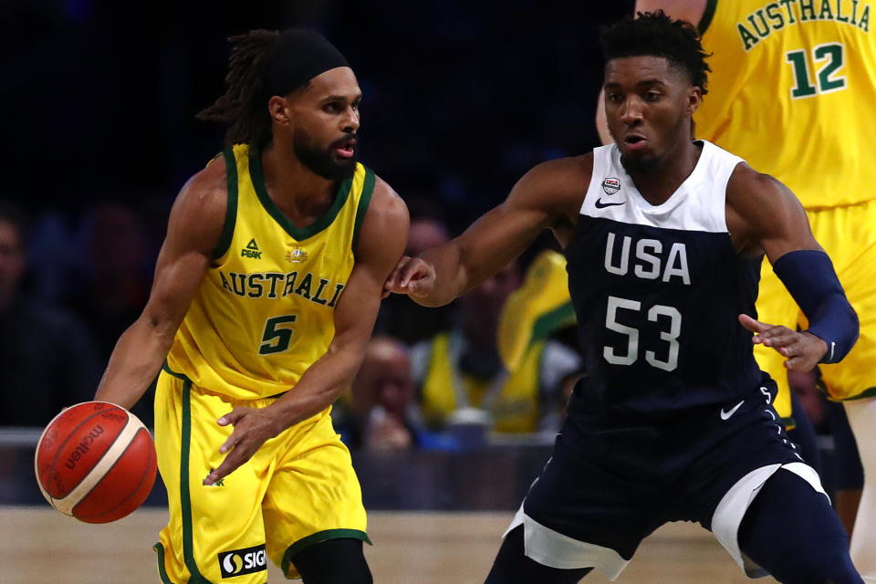 MELBOURNE, AUSTRALIA - AUGUST 24: Patty Mills of the Boomers (L)  handles the ball under pressure from Donovan Mitchell of the USA during game two of the International Basketball series between the Australian Boomers and United States of America at Marvel Stadium on August 24, 2019 in Melbourne, Australia. (Photo by Kelly Defina/Getty Images)