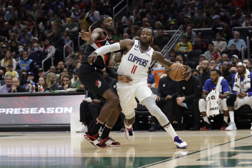 Los Angeles Clippers' John Wall drives past Portland Trailblazers' Jerami Grant.