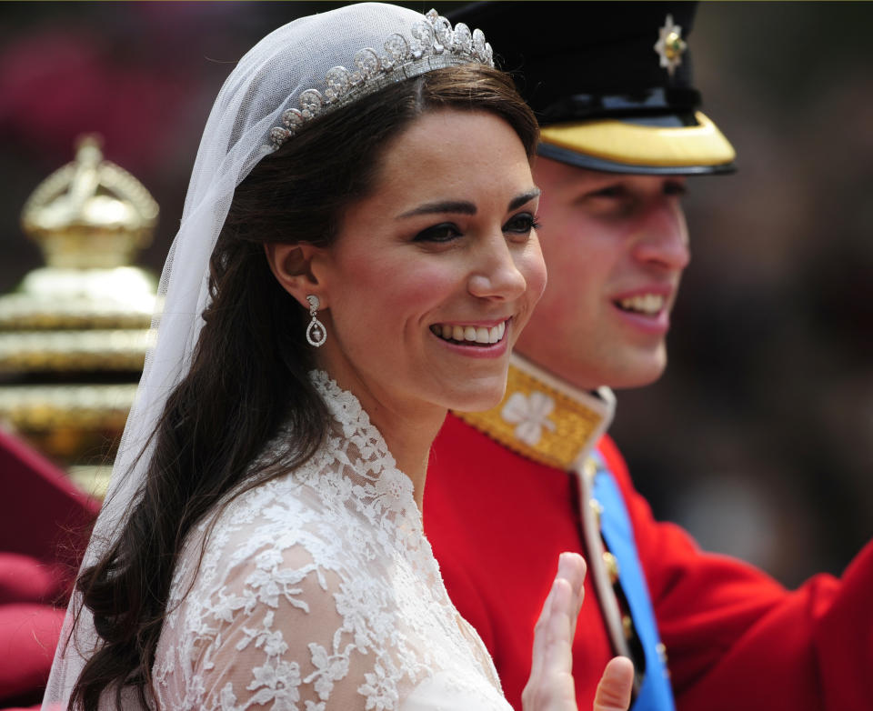 Britain's Prince William and Catherine, Duchess of Cambridge travel to Buckingham Palace in the 1902 State Landau, along the Procession Route, after their wedding in Westminster Abbey, in central London April 29, 2011. Prince William married his fiancee, Kate Middleton, in Westminster Abbey on Friday.  (ROYAL WEDDING/ PROCESSION)     REUTERS/Kieran Doherty (BRITAIN  - Tags: ROYALS ENTERTAINMENT SOCIETY)