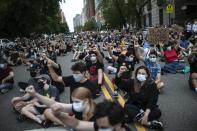 Protesters sit together with their fists in the air during a solidarity rally calling for justice over the death of George Floyd, Wednesday, June 3, 2020, in New York. Floyd died in police custody in Minneapolis on May 25. (AP Photo/Wong Maye-E)