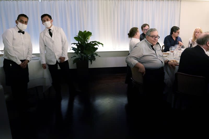 Wait staff keep an eye on the dining room at Il Gattopardo restaurant