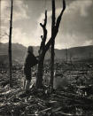 Four months after the U.S. atomic bombing of Nagasaki, an unidentified person stands beside a seared tree amid ruins and rubble, Nagasaki, Japan, Dec. 9, 1945. (Photo: Alfred Eisenstaedt/The LIFE Picture Collection/Getty Images)