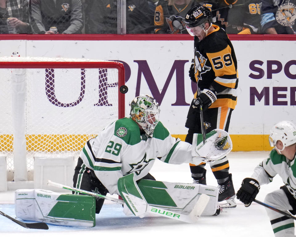 Pittsburgh Penguins' Jake Guentzel (59) can't get his stick on a rebound off Dallas Stars goaltender Jake Oettinger (29) during the first period of an NHL hockey game in Pittsburgh, Tuesday, Oct. 24, 2023. (AP Photo/Gene J. Puskar)