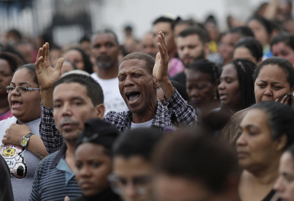 A protester shouts for justice during a gathering in memory of the late 8-year-old Ágatha Sales Félix in the Alemao complex slum of Rio de Janeiro, Brazil, Sunday, Sept. 22, 2019. Félix was hit by a stray bullet Friday amid what police said was a shootout with suspected criminals. However, residents say there was no shootout, and blame police.