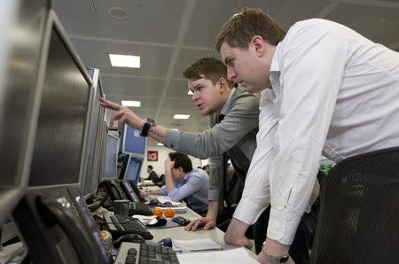 Traders react on the IG Group trading floor in London March 18, 2013. REUTERS/Neil Hall