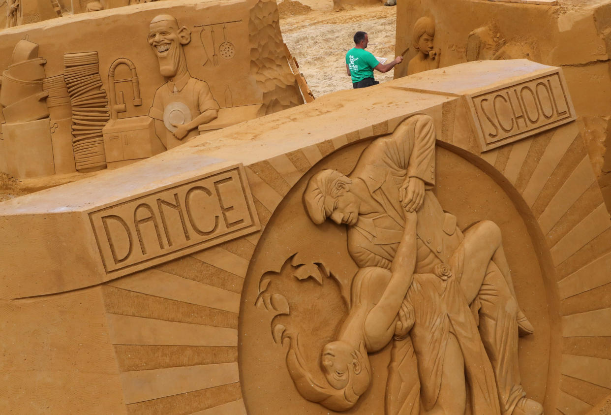 A sand carver works on a sculpture during the Sand Sculpture Festival "Dreams" in Ostend, Belgium June 18, 2019. (Photo: Yves Herman/Reuters)