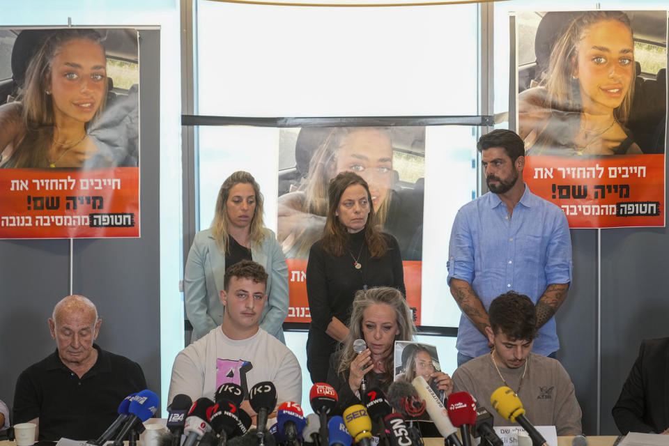 Members of Mia Schem's family and representatives of the families of the abducted and missing persons held by Hamas militants in Gaza hold a press conference following the release of a video by Hamas, in which the 21-year-old Israeli woman is seen. Schem was among the roughly 200 people kidnapped in Hamas' cross-border attack on Oct. 7. in Tel Aviv, Israel, Tuesday, Oct. 17, 2023. (AP Photo/Ohad Zwigenberg)