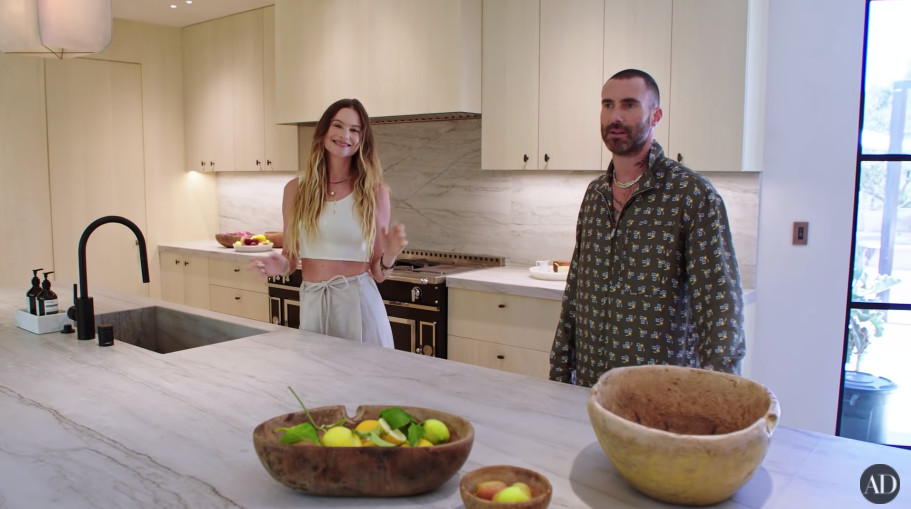 Adam and Behati standing in their kitchen