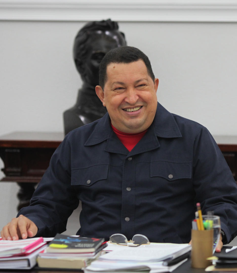 In this photo released by Miraflores Press Office, Venezuela's President Hugo Chavez smiles as he leads a televised Cabinet meeting at Miraflores presidential palace in Caracas, Venezuela, Tuesday, May 22, 2012. Chavez has reappeared on television a week and a half after returning from cancer treatment in Cuba. (AP Photo/Miraflores Press Office, Marcelo Garcia)