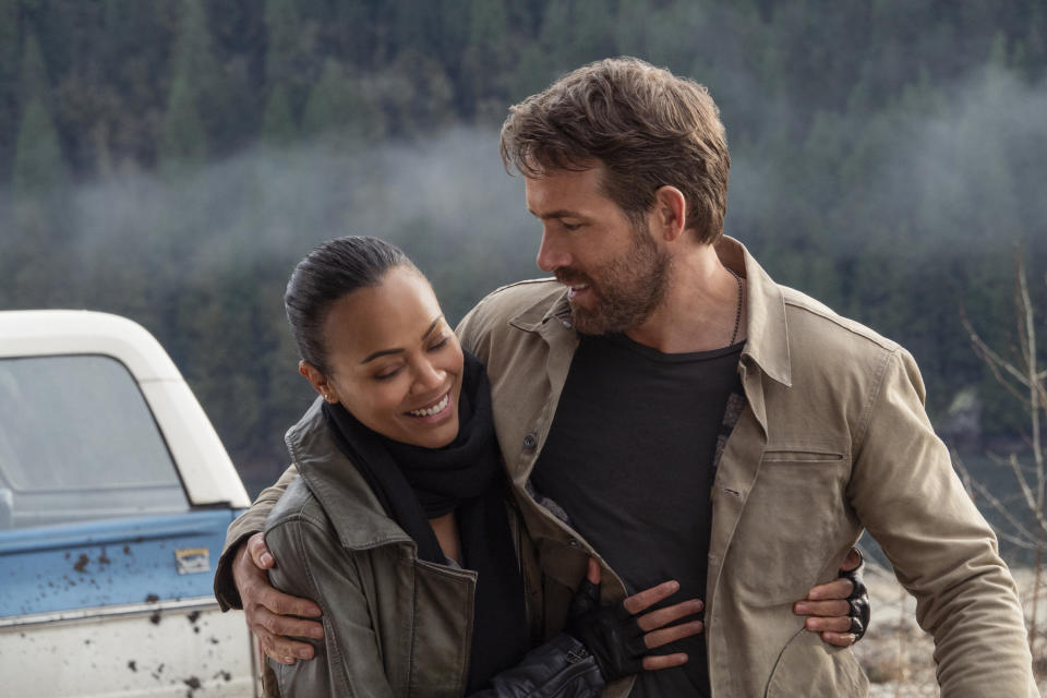 This image released by Netflix shows Zoe Saldana, left, and Ryan Reynolds in a scene from "The Adam Project." (Doane Gregory/Netflix via AP)