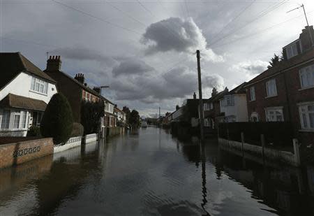 Grey clouds hang over flooded homes at Egham after the River Thames burst its banks in southeast England February 13, 2014. REUTERS/Luke MacGregor