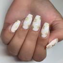 <p>Make your white base pop with some gold branded nail art.</p><p><a href="https://www.instagram.com/p/B0OQtPAB86s/" rel="nofollow noopener" target="_blank" data-ylk="slk:See the original post on Instagram;elm:context_link;itc:0;sec:content-canvas" class="link ">See the original post on Instagram</a></p>