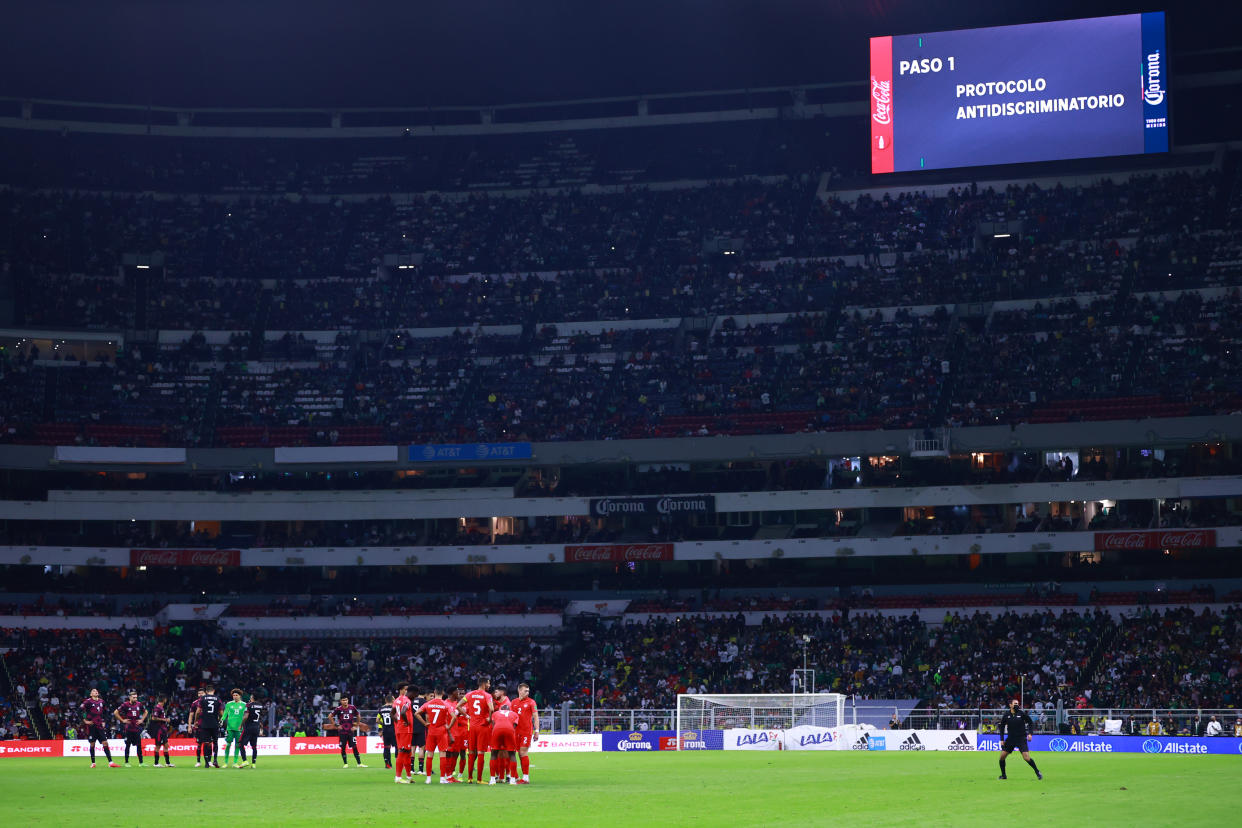 MEXICO CITY, MEXICO - OCTOBER 07: Players gather in the middle of the field after the referee momentarily halted the game due to discriminatory shouts from fans during the match between Mexico and Canada as part of the Concacaf 2022 FIFA World Cup Qualifier at Azteca Stadium on October 07, 2021 in Mexico City, Mexico. (Photo by Hector Vivas/Getty Images)