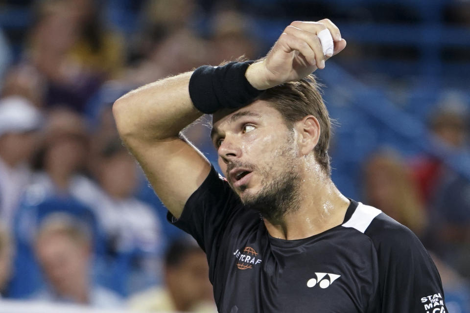 Stan Wawrinka, of Switzerland, reacts during a match against Roger Federer, of Switzerland, in the quarterfinals of the Western & Southern Open tennis tournament, Friday, Aug. 17, 2018, in Mason, Ohio. (AP Photo/John Minchillo)