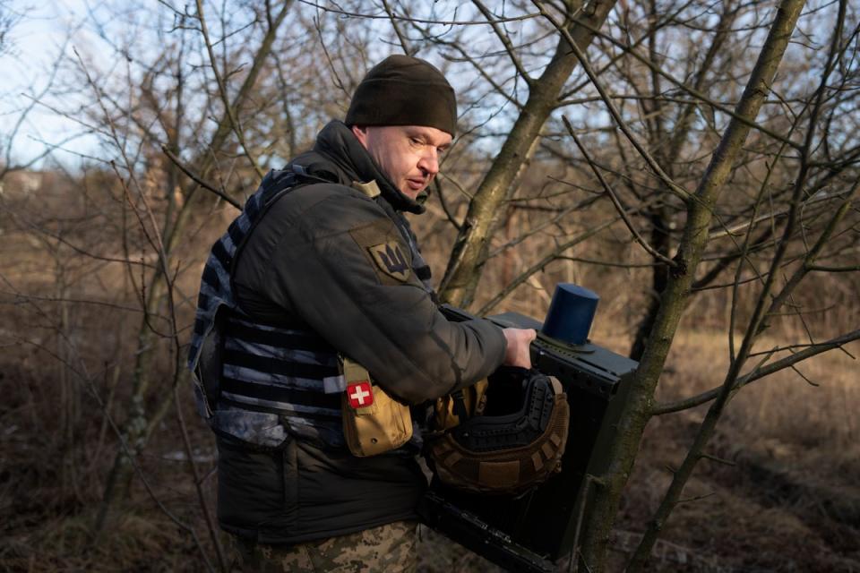 A Ukrainian soldier installs an electronic warfare system to quell Russian drones at the front line (Copyright 2024 The Associated Press. All rights reserved)