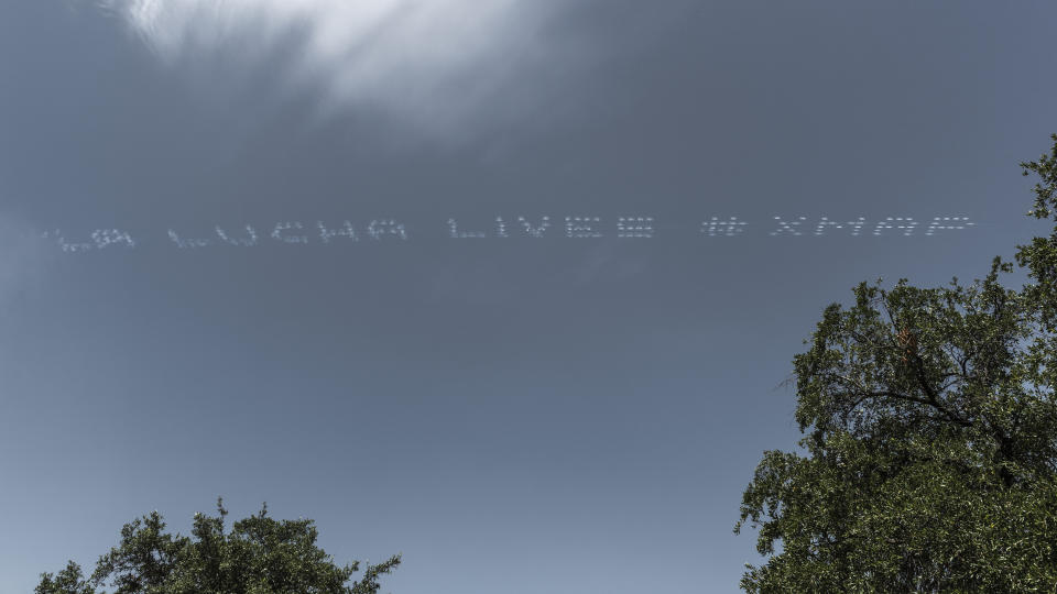 The skytyped phrase "LA LUCHA LIVES," chosen by artist Cruz Ortiz is seen over the Central Texas Detention Facility during the In Plain Sight day of action on July 3 in San Antonio. Photo by Anthony Francis. (Photo: Anthony Francis)