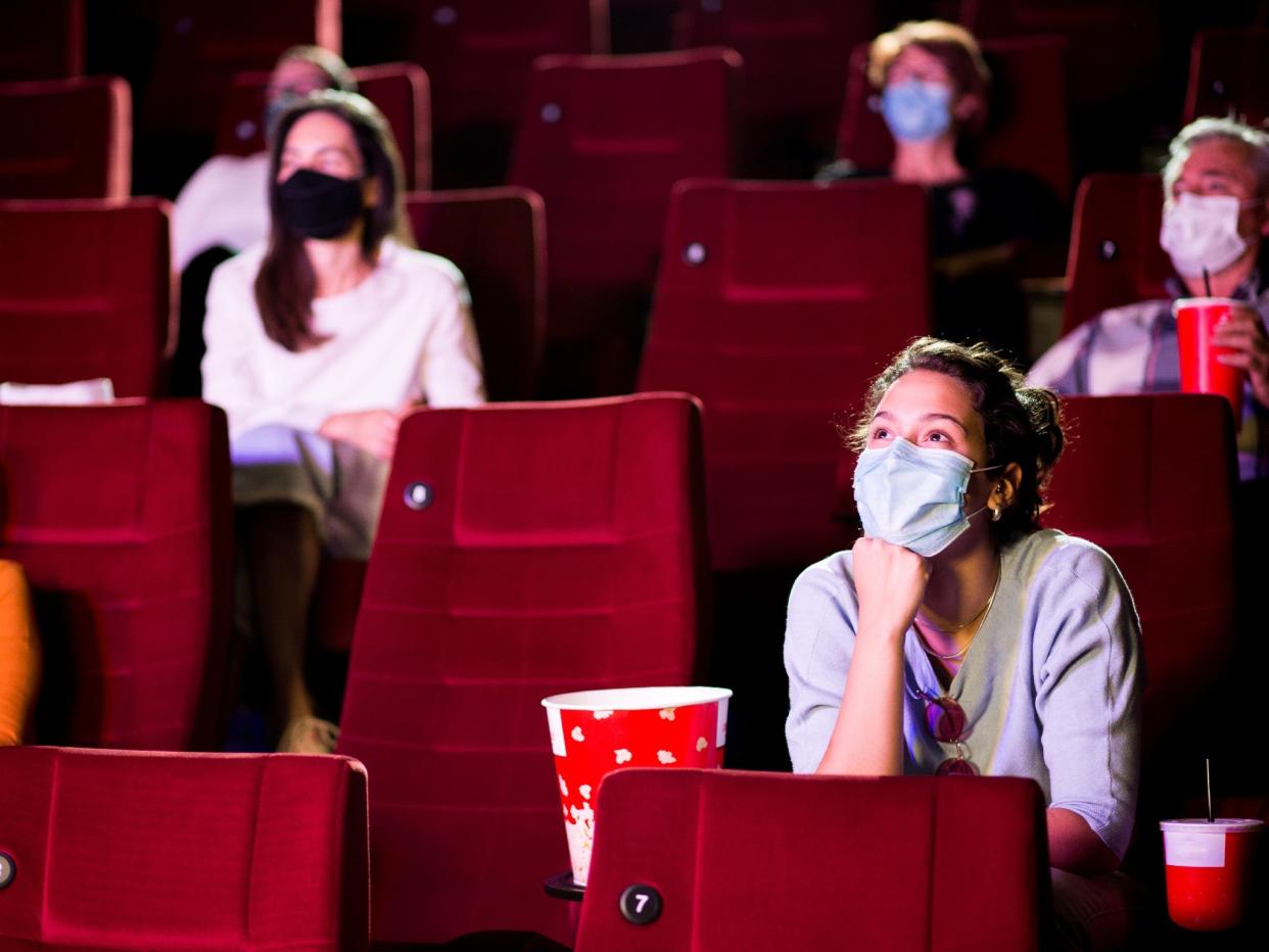 Audience at the cinema wearing protective masks and sitting in a socially-distanced manner (iStock/Getty Images)