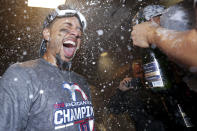 Boston Red Sox right fielder Mookie Betts celebrates in the locker room after winning the baseball American League Championship Series against the Houston Astros on Thursday, Oct. 18, 2018, in Houston. Red Sox won 4-1. (AP Photo/David J. Phillip)