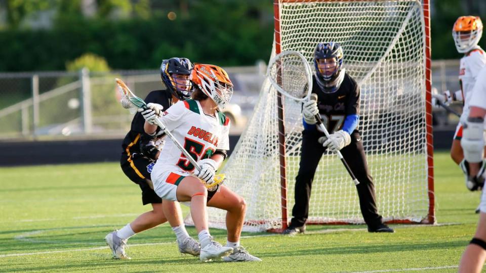 Frederick Douglass attacker Jimmy Hooks (50) looks to turn toward the goal defended by Henry Clay’s Arlo Johnson (37) during Wednesday’s game at Douglass. Johnson made nine saves for the Blue Devils.