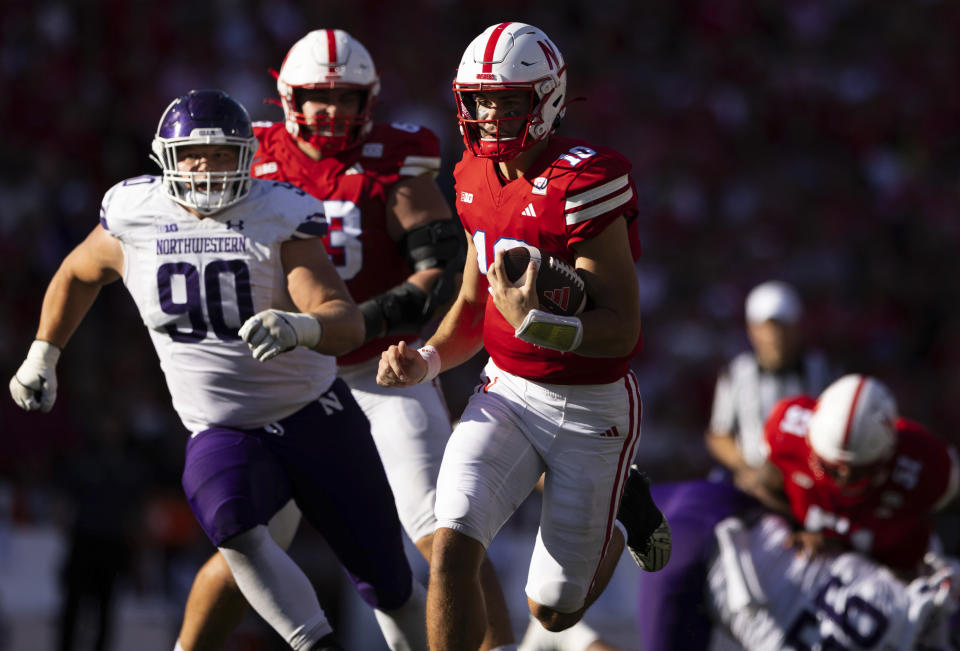 Nebraska quarterback Heinrich Haarberg (10) rushes against Northwestern's Carmine Bastone (90) during the first half of an NCAA college football game Saturday, Oct. 21, 2023, in Lincoln, Neb. (AP Photo/Rebecca S. Gratz)