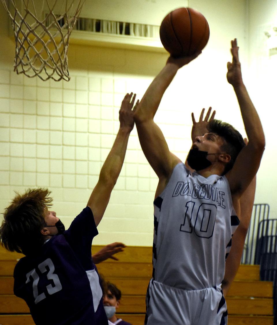 Dolgeville Blue Devil Kamryn Comstock (10) puts back a rebound against West Canada Valley during the fourth quarter of Friday's game.