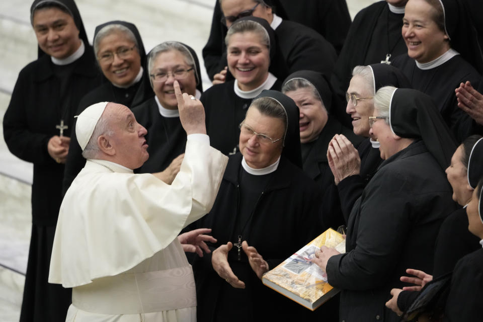 FILE - Pope Francis salutes a group of nuns at the end of his weekly general audience in the Paul VI Hall the Vatican, Nov. 24, 2021. Pope Francis is celebrating his 85th birthday Friday, Dec. 17, 2021, a milestone made even more remarkable given the coronavirus pandemic, his summertime intestinal surgery and the weight of history: His predecessor retired at this age and the last pope to have lived any longer was Leo XIII over a century ago. (AP Photo/Andrew Medichini, file)