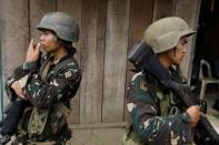 Philippines army soldiers take positions as government forces continue their assault against insurgents from the Maute group, who have taken over large parts of Marawi City, Philippines June 25, 2017. REUTERS/Jorge Silva