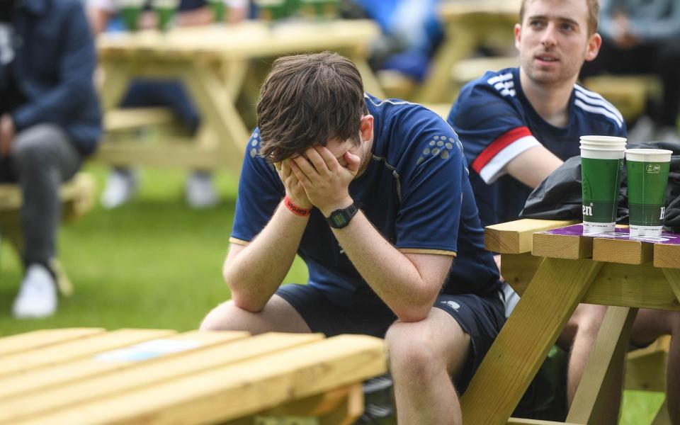 Scotland fans react while watching the match at a public viewing outside the stadium on June 14, 2021 in Glasgow - Peter Summers/Getty Images