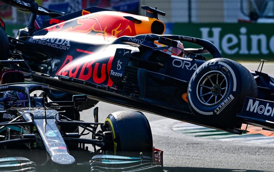 Red Bull's Dutch driver Max Verstappen (R) and Mercedes' British driver Lewis Hamilton collide during the Italian Formula One Grand Prix at the Autodromo Nazionale circuit in Monza, on September 12, 2021. - AFP